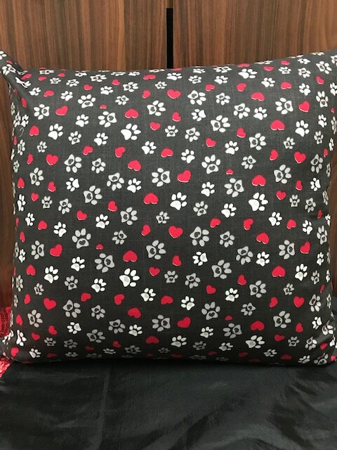 IMG_8123 A 19 inch square cushion or cushion cover with grey and white paws with pink hearts on a grey background. Cushion has a lovely matching pink zip.